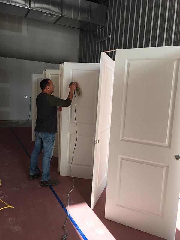 Worker Painting a Door