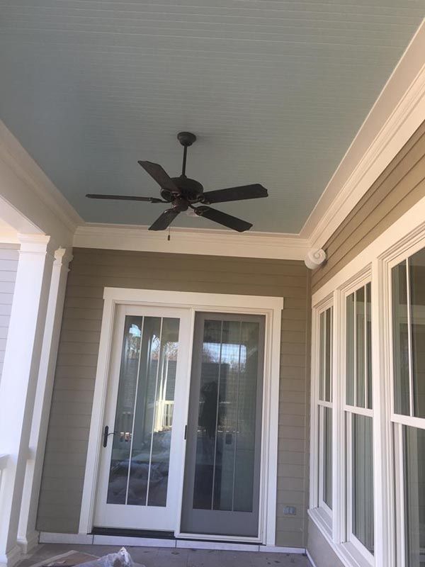 Ceiling Fan is Hanging from the Ceiling of a Porch