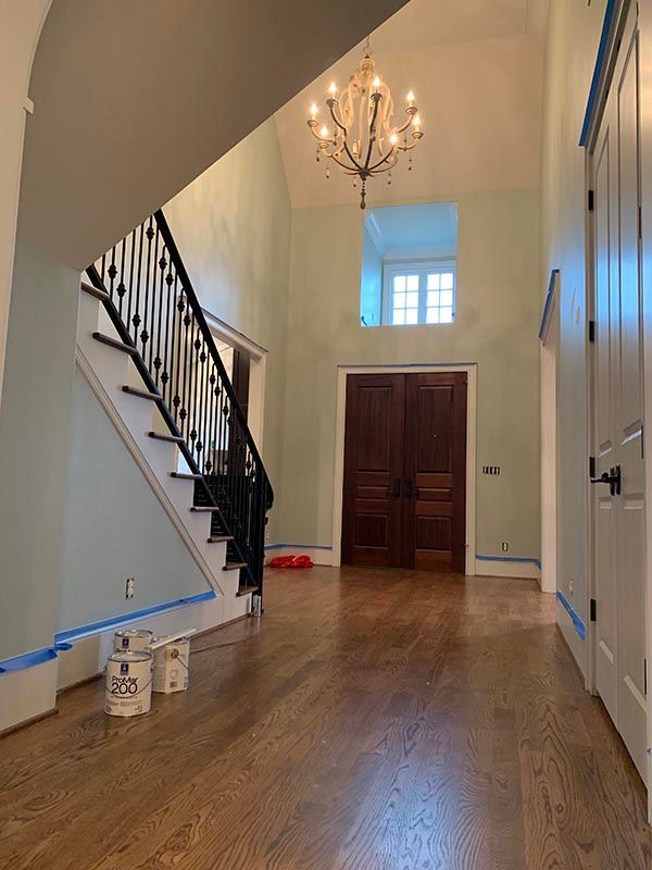 Hallway with a Staircase and a Chandelier