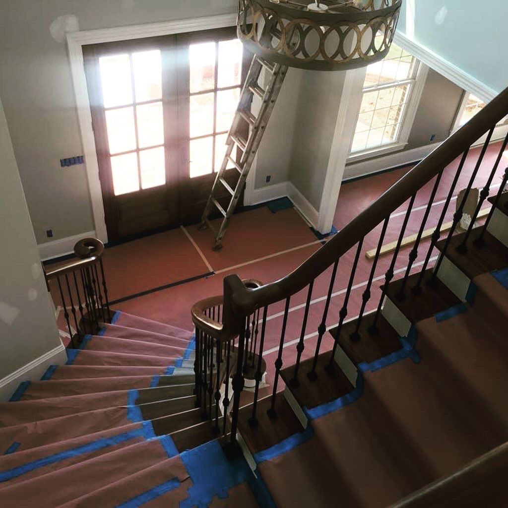 Staircase with a Ladder and a Chandelier