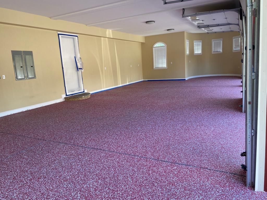 An empty room with a purple carpet and a white door