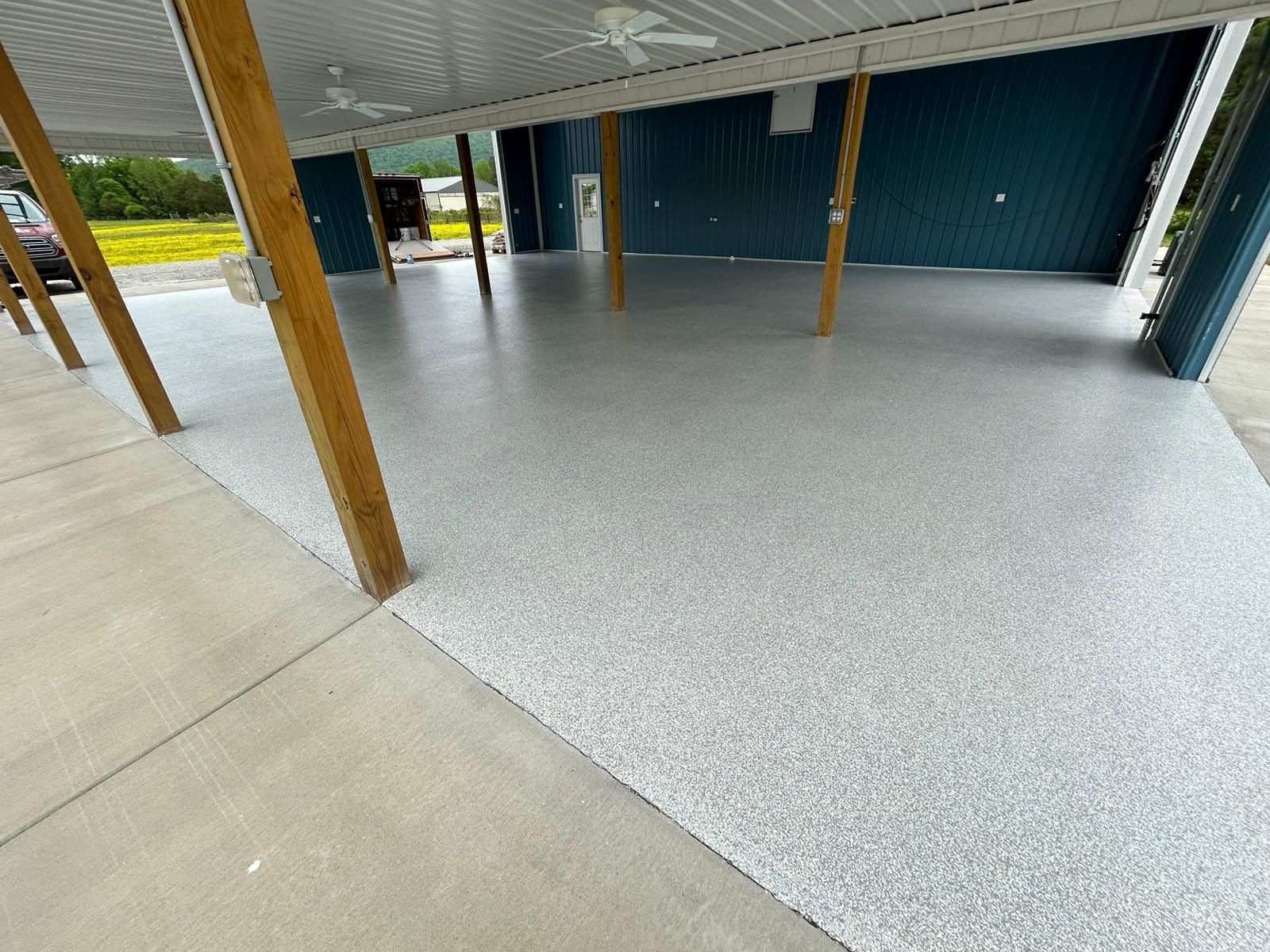 A garage with a concrete floor and a ceiling fan.