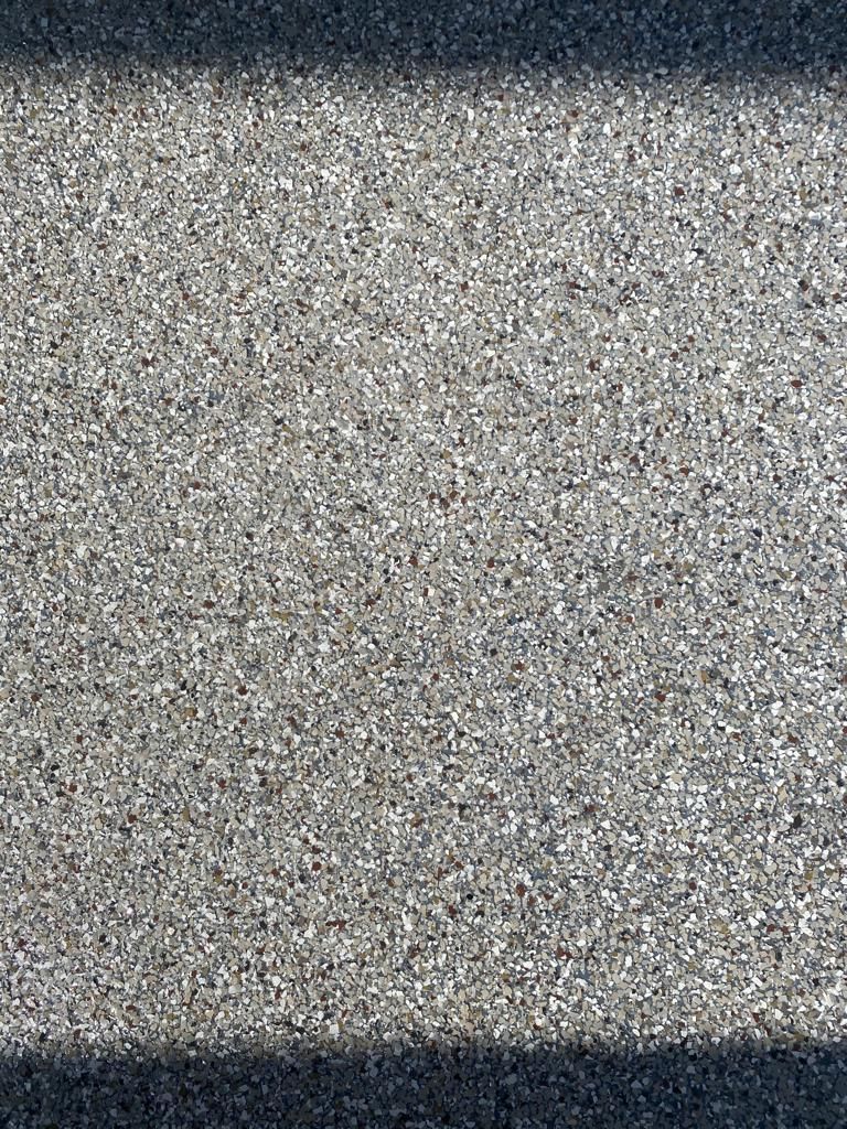 A close up of a gray and black carpet texture.