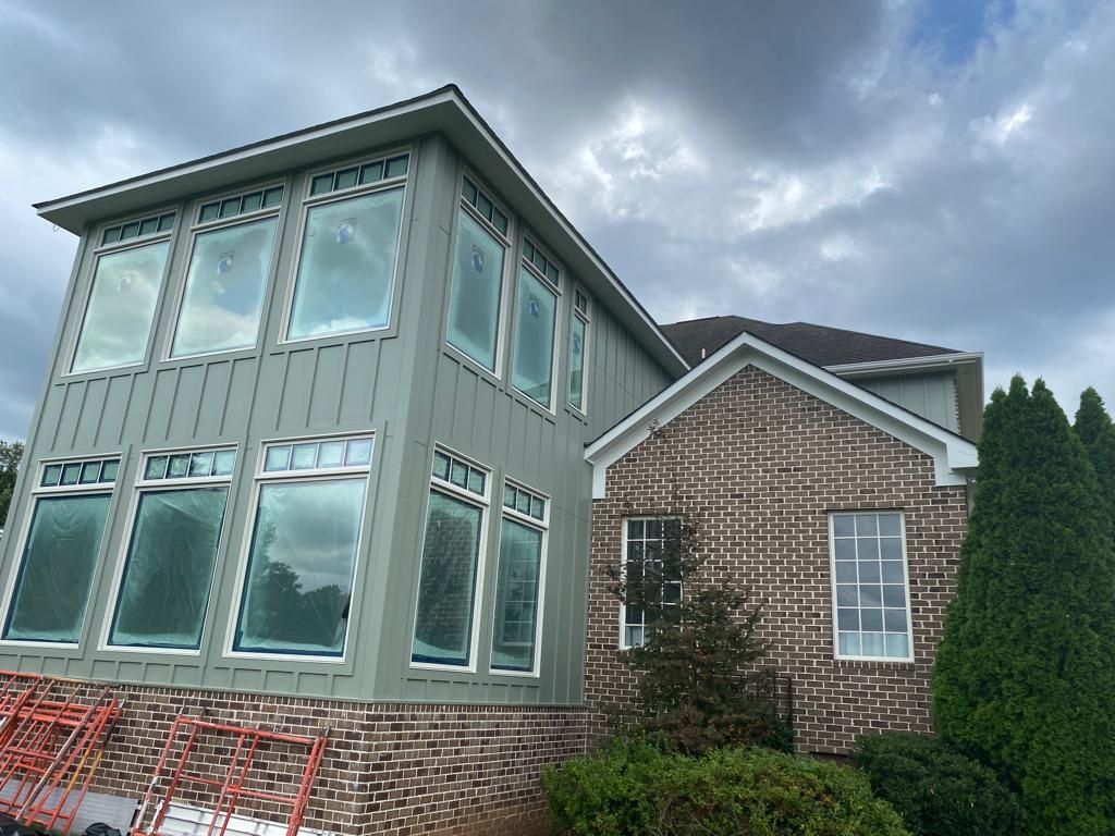 A large house with a lot of windows is being remodeled.