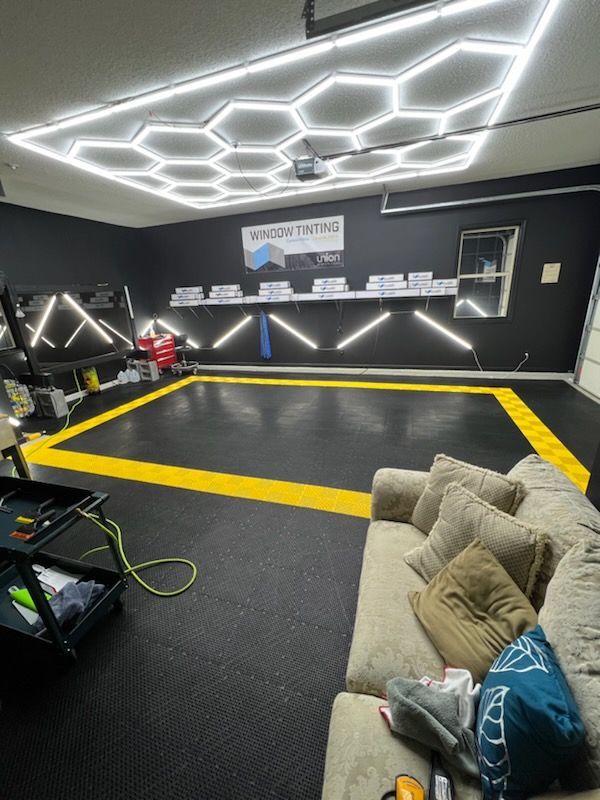 A living room with a couch and a yellow line on the floor.