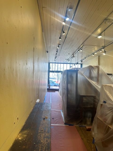 A long hallway in a building covered in plastic.