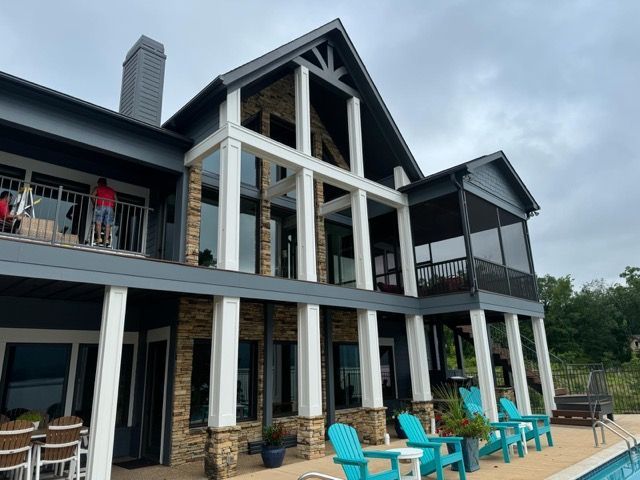 A large house with a swimming pool in front of it.