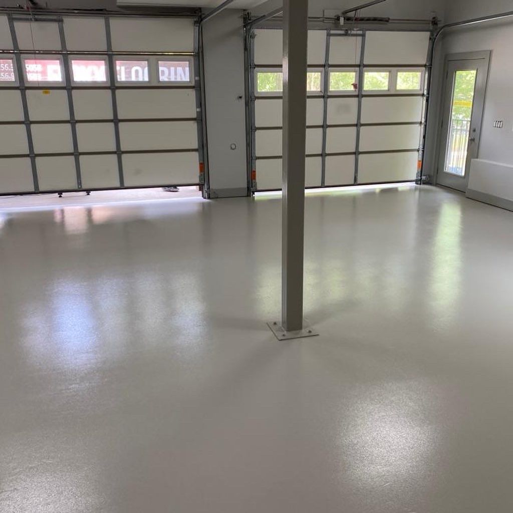 A garage with a white floor and a garage door.