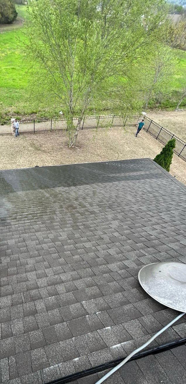 A plate is sitting on top of a roof next to a hose.