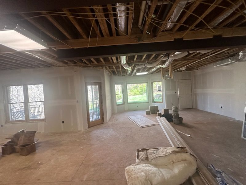 A large room with a lot of windows and a ceiling that is being remodeled.