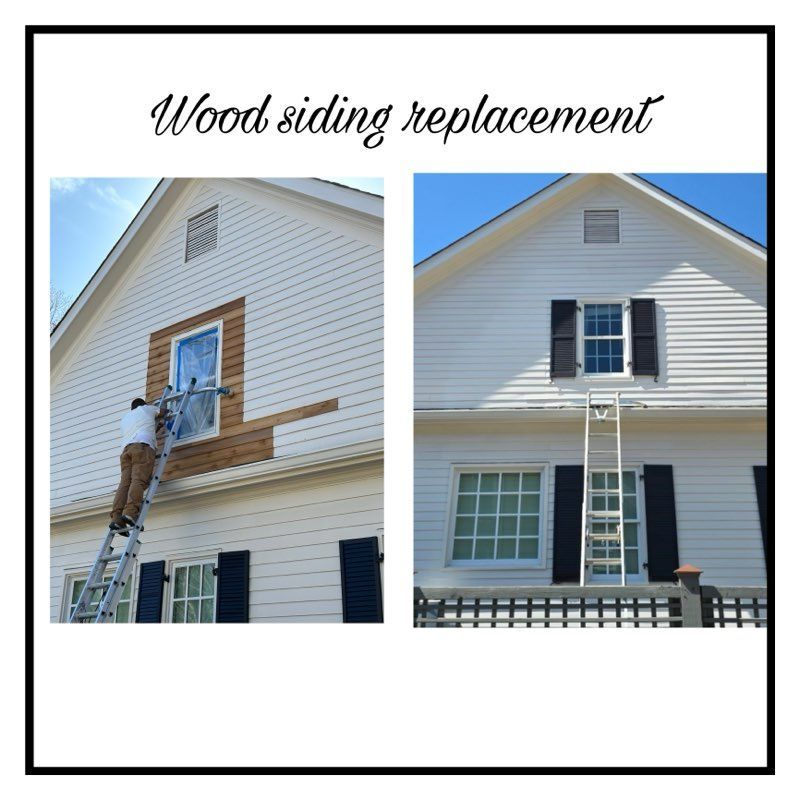 A man on a ladder is painting the side of a house.