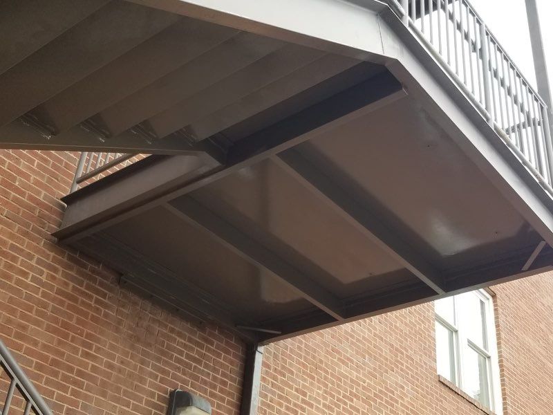 A brick building with a metal staircase leading up to it