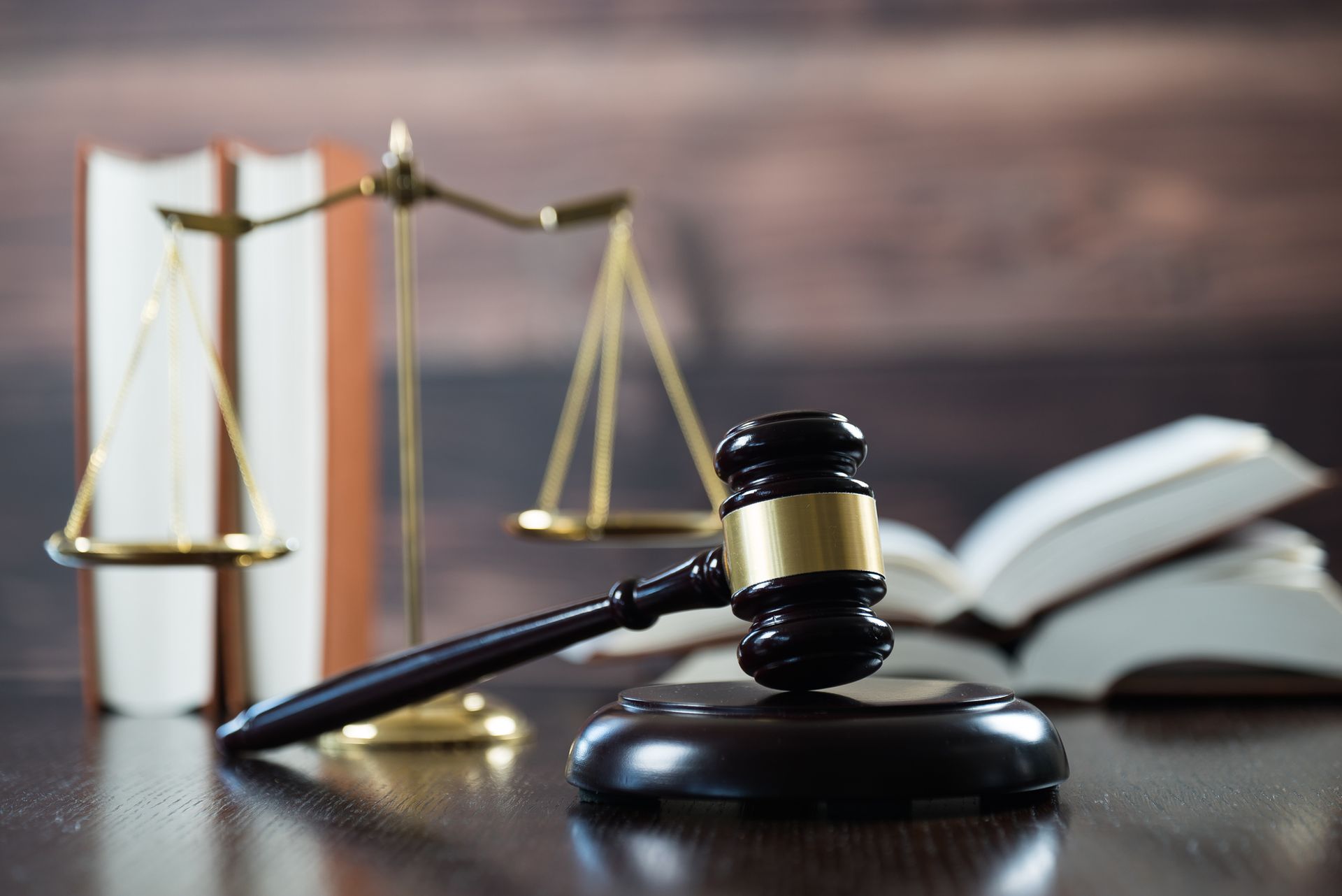A judge 's gavel , scales of justice , and books are on a table.