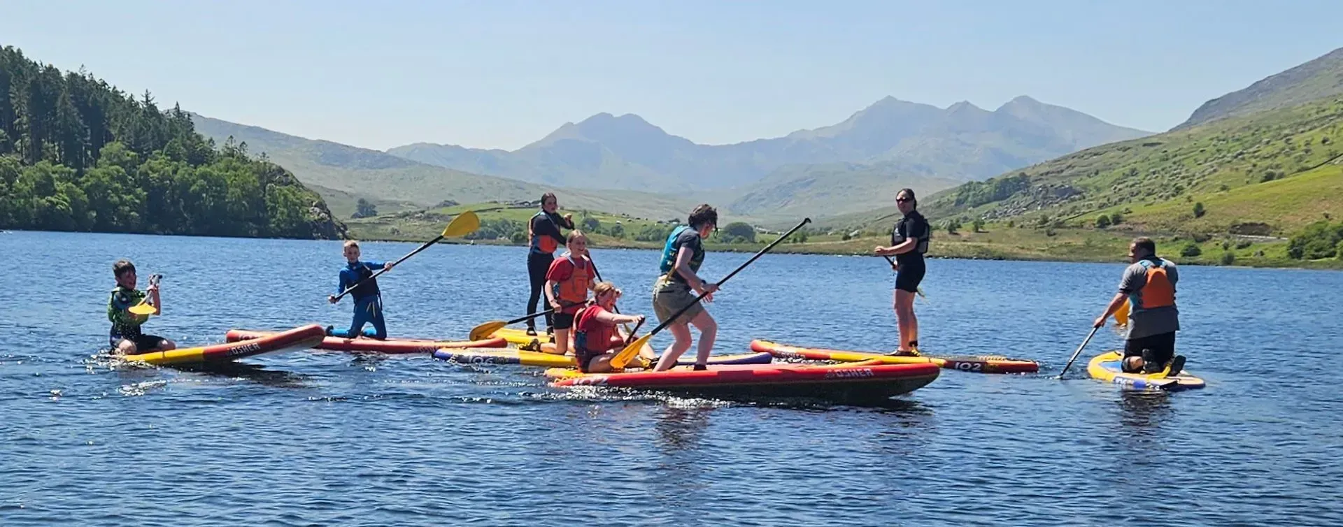 A group of people are floating on rafts in a lake.