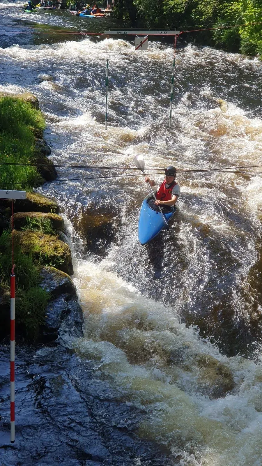 A person is riding a kayak down a river.