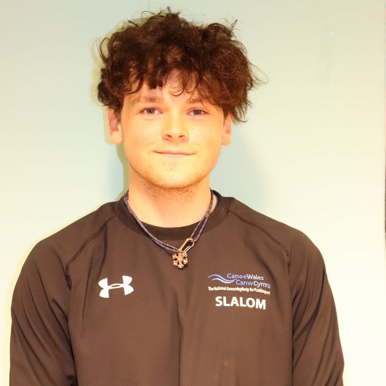 A young man wearing a black shirt that says slalom