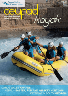 A group of people are rowing a raft down a river.