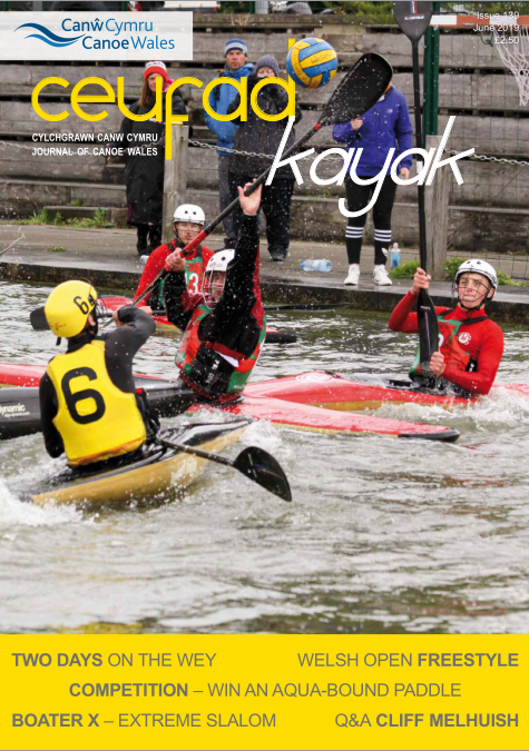 A group of people are rowing kayaks in the water.