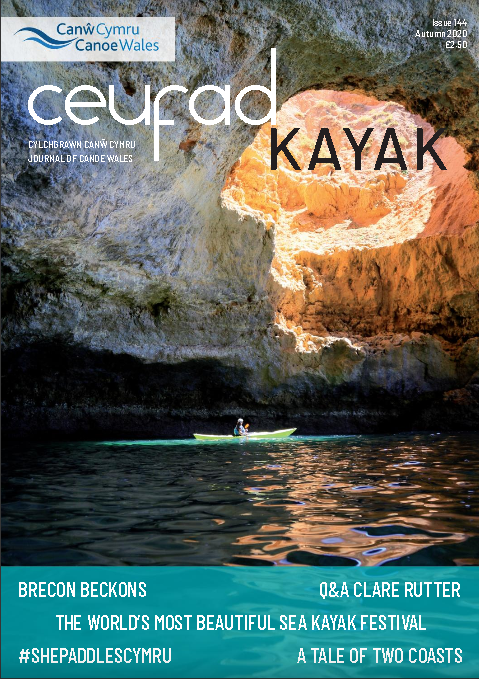 A magazine cover with a person in a kayak on it.