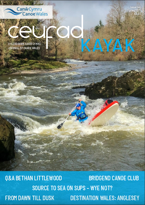 A magazine cover with a person in a kayak on it