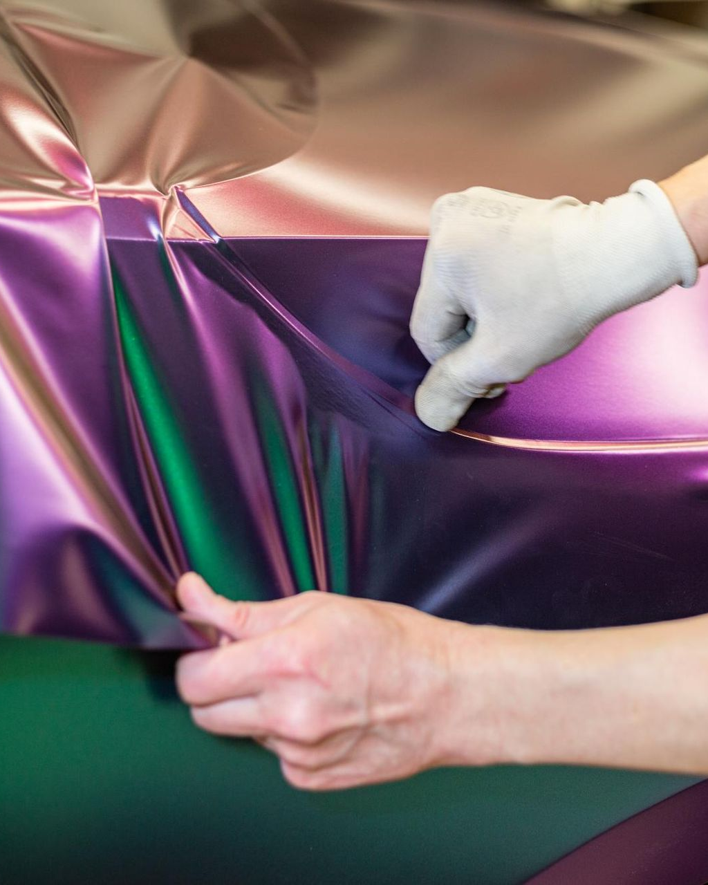 A yellow sports car is parked in a garage.