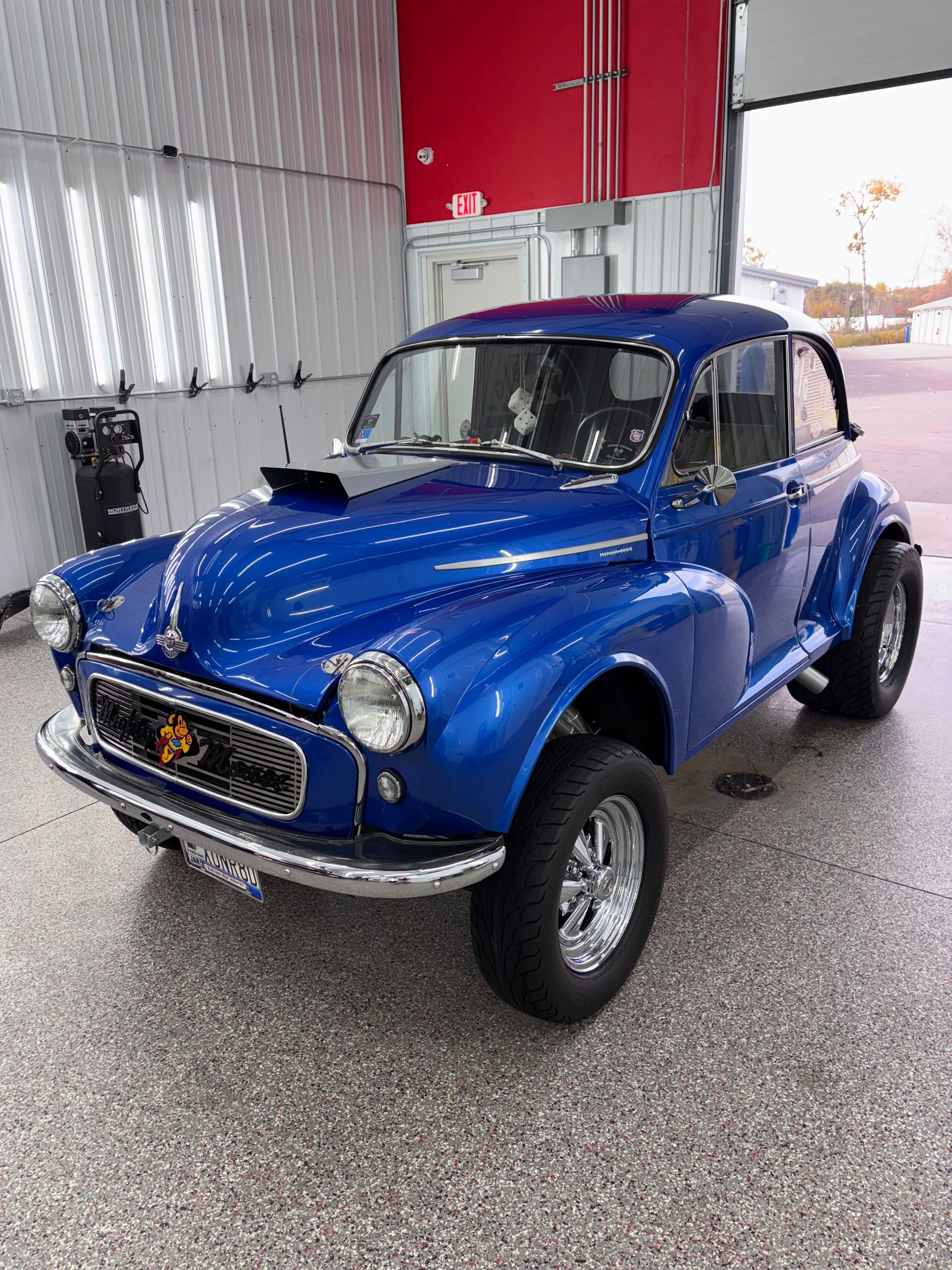 A yellow sports car is parked in a garage.