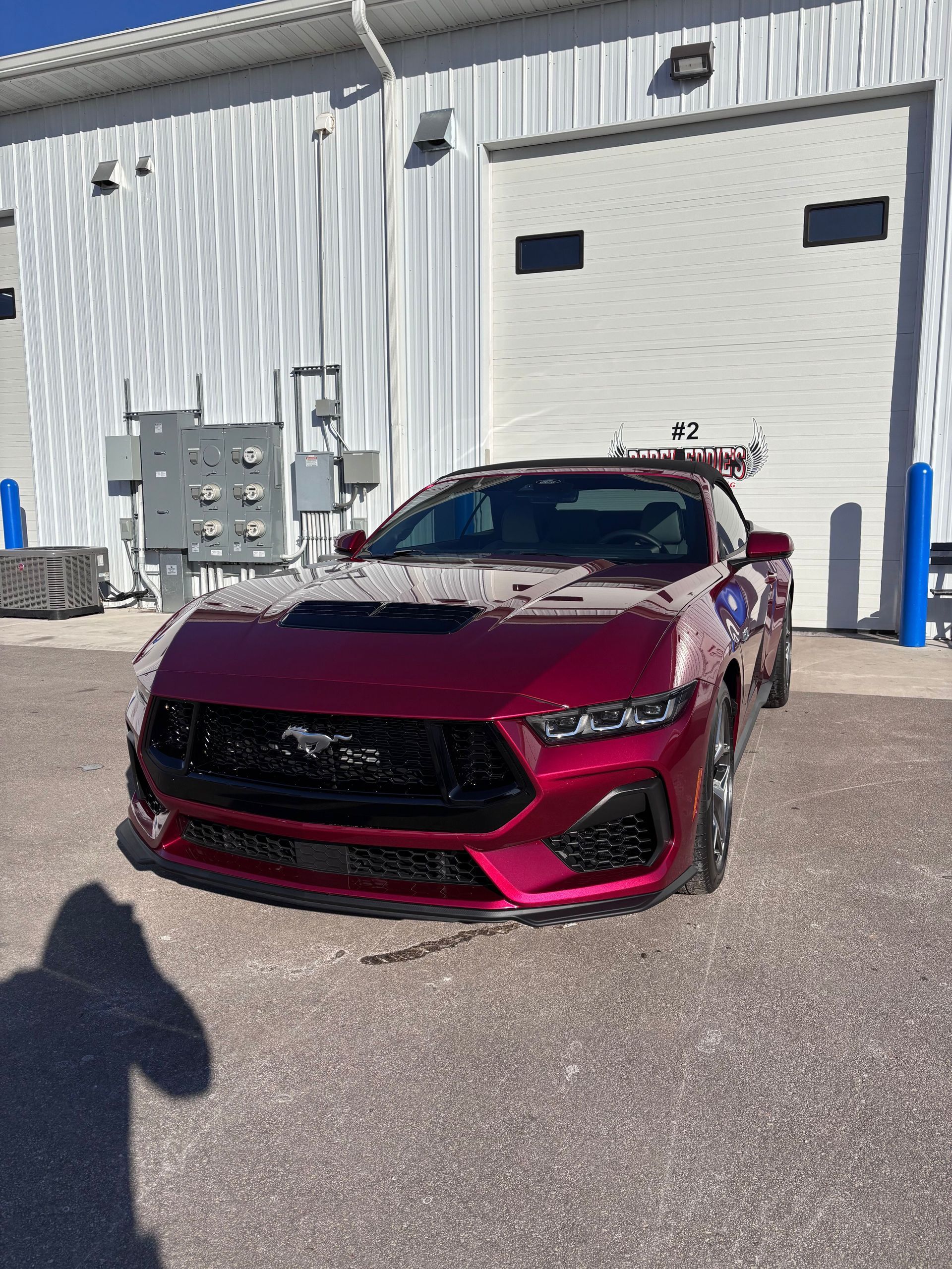 A yellow sports car is parked in a garage.