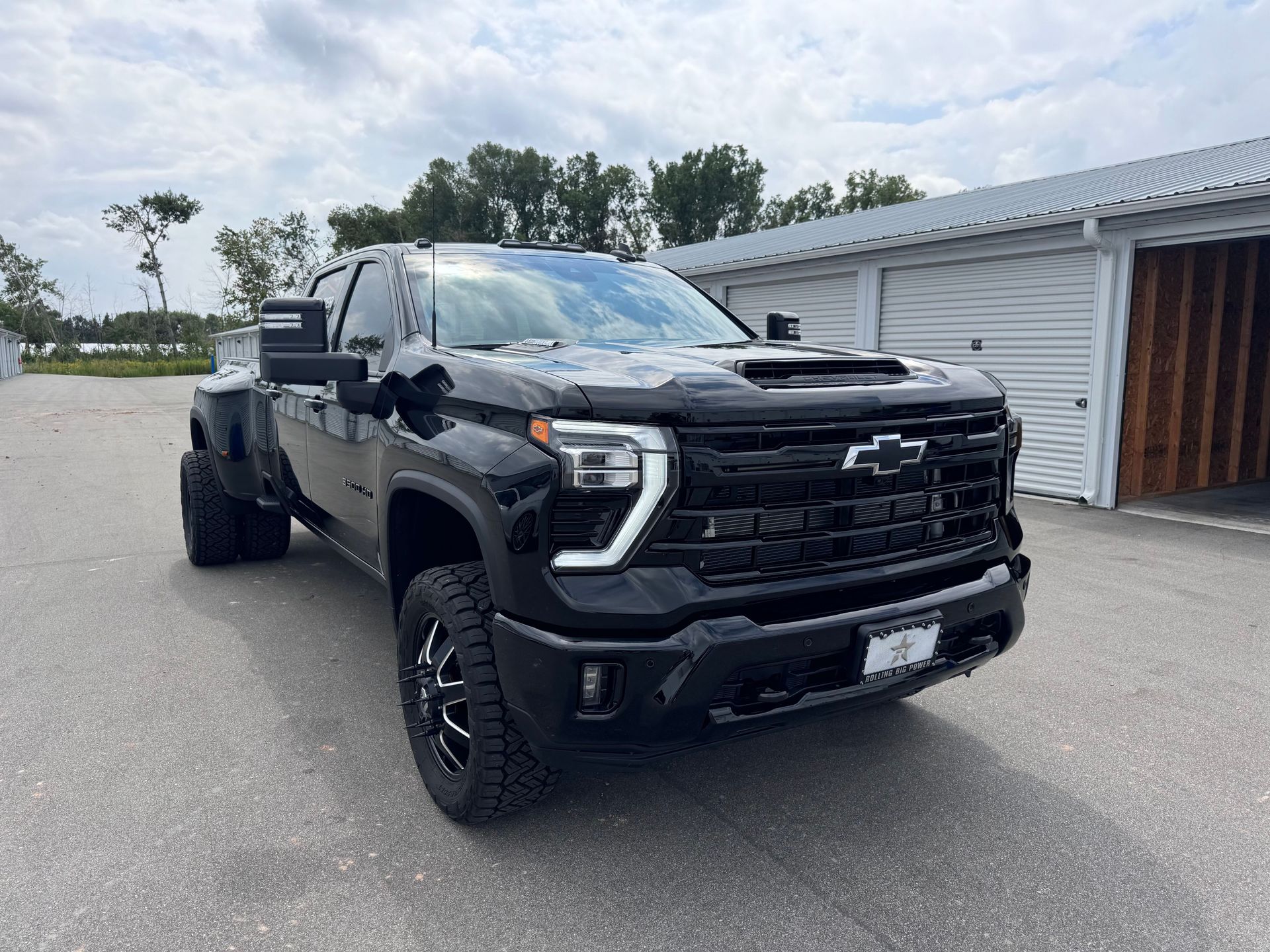 A close up of water drops on the hood of a car