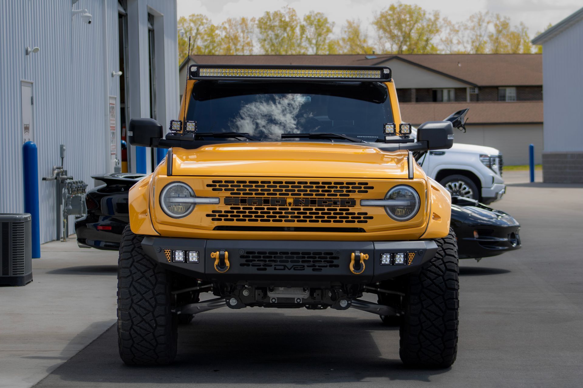 A close up of water drops on the hood of a car