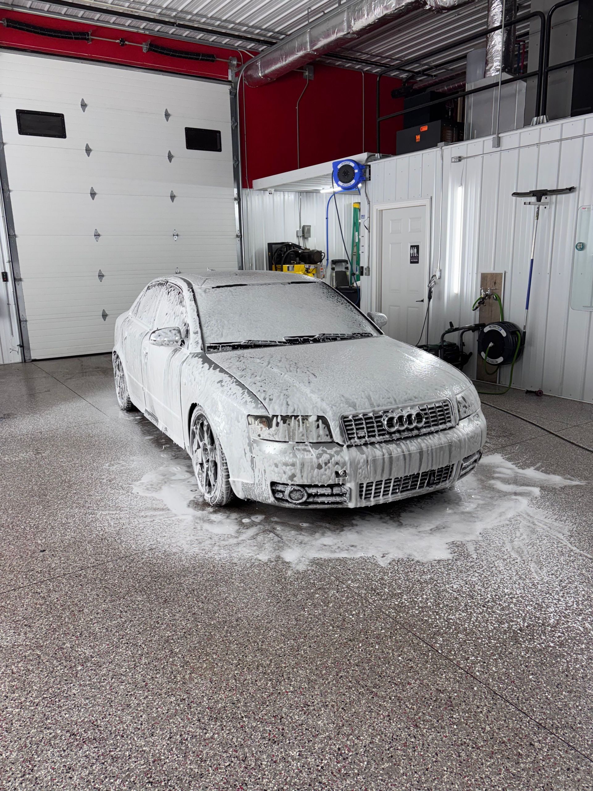 A close up of water drops on the hood of a car