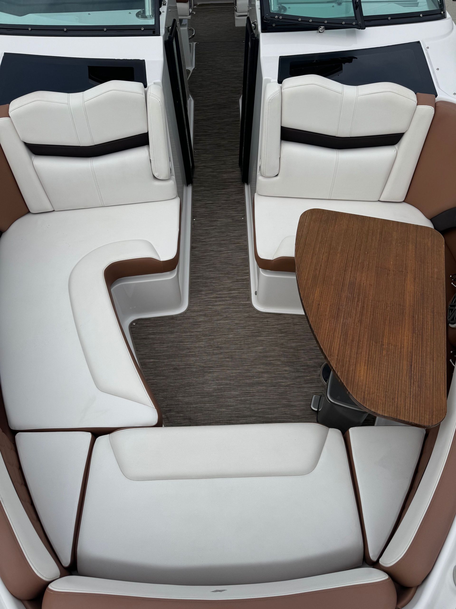 A person wearing black gloves is polishing a black car