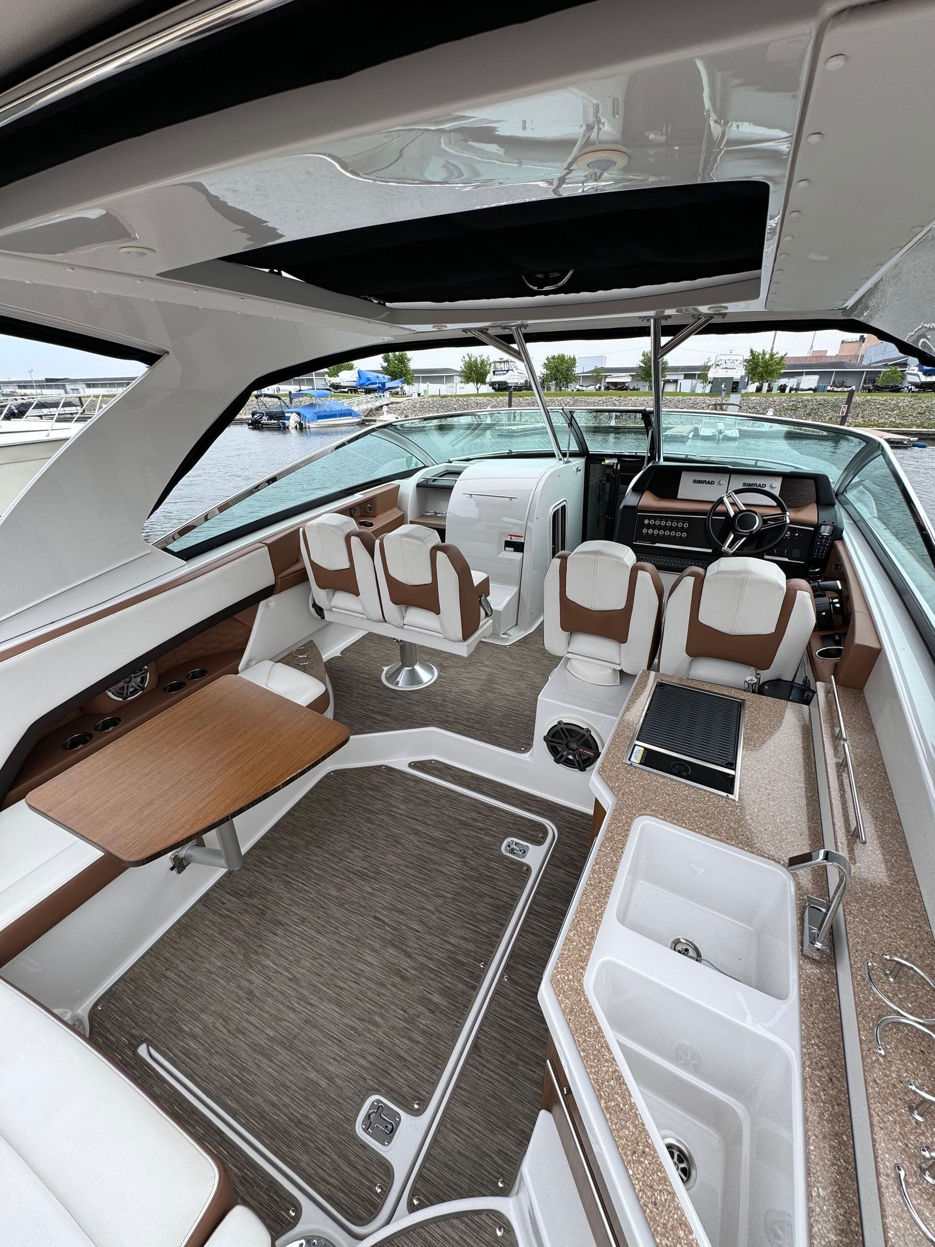 A person wearing black gloves is polishing the hood of a red car.