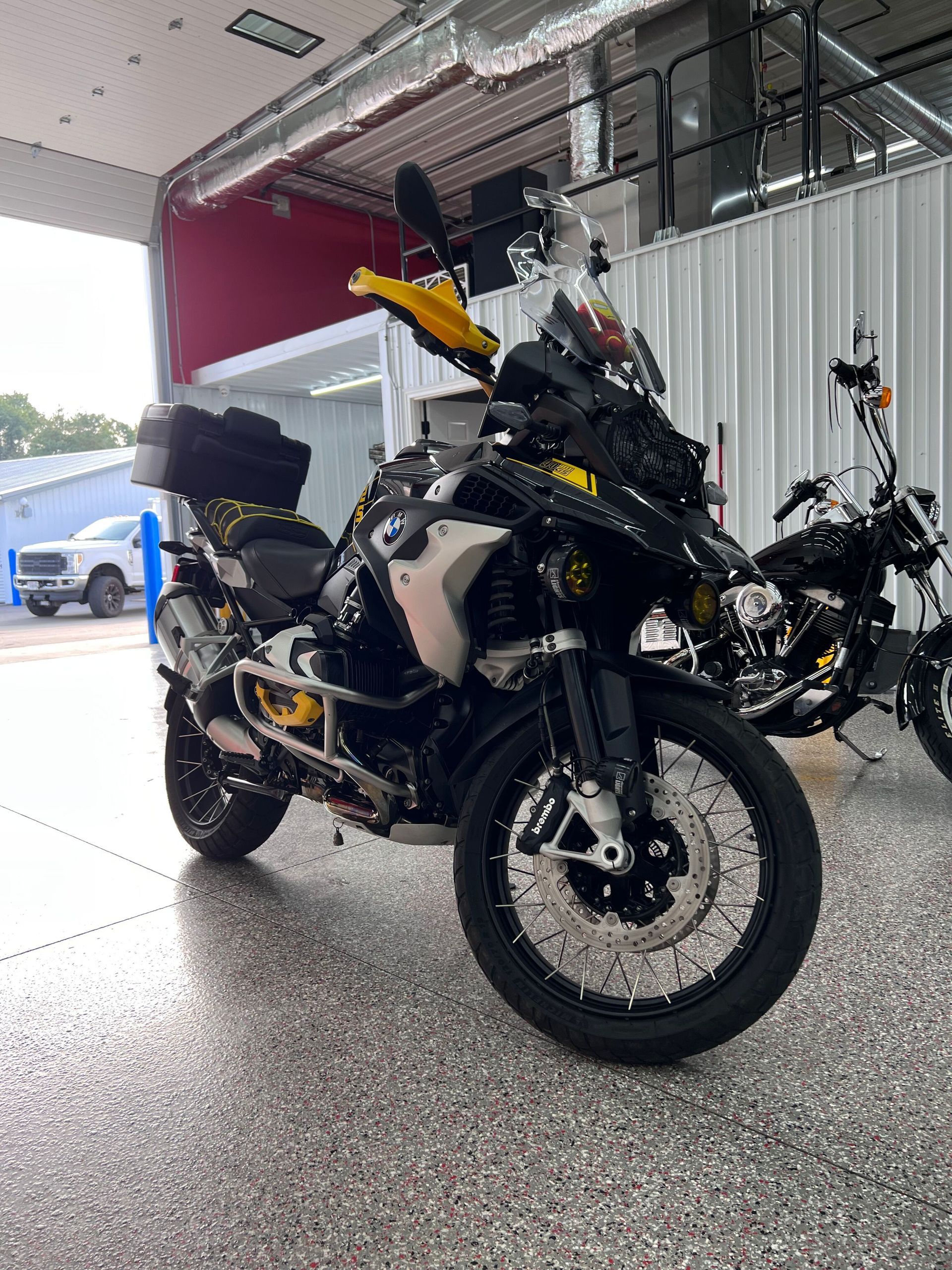 A close up of water drops on the hood of a car