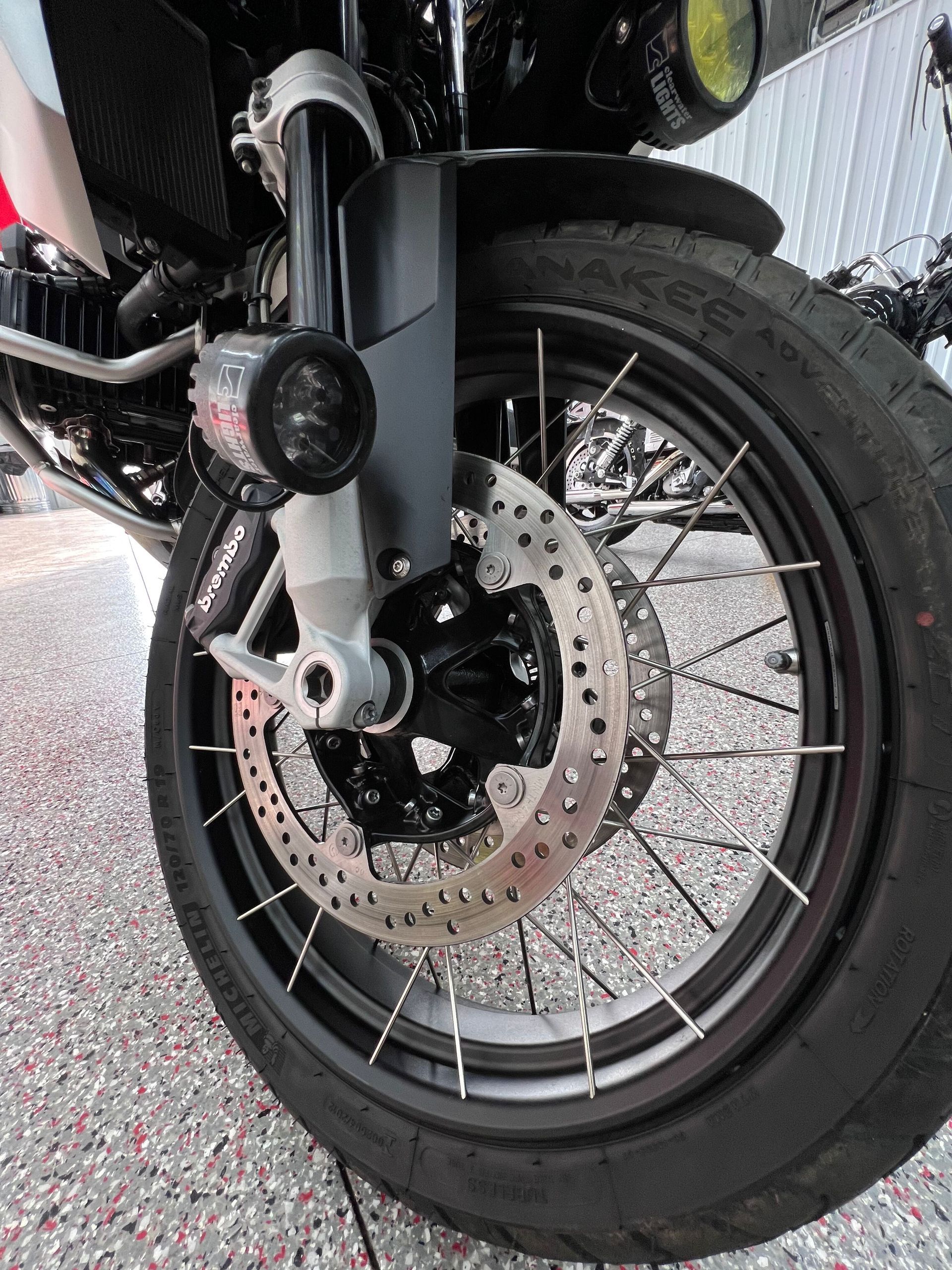 A yellow sports car is parked in a garage.