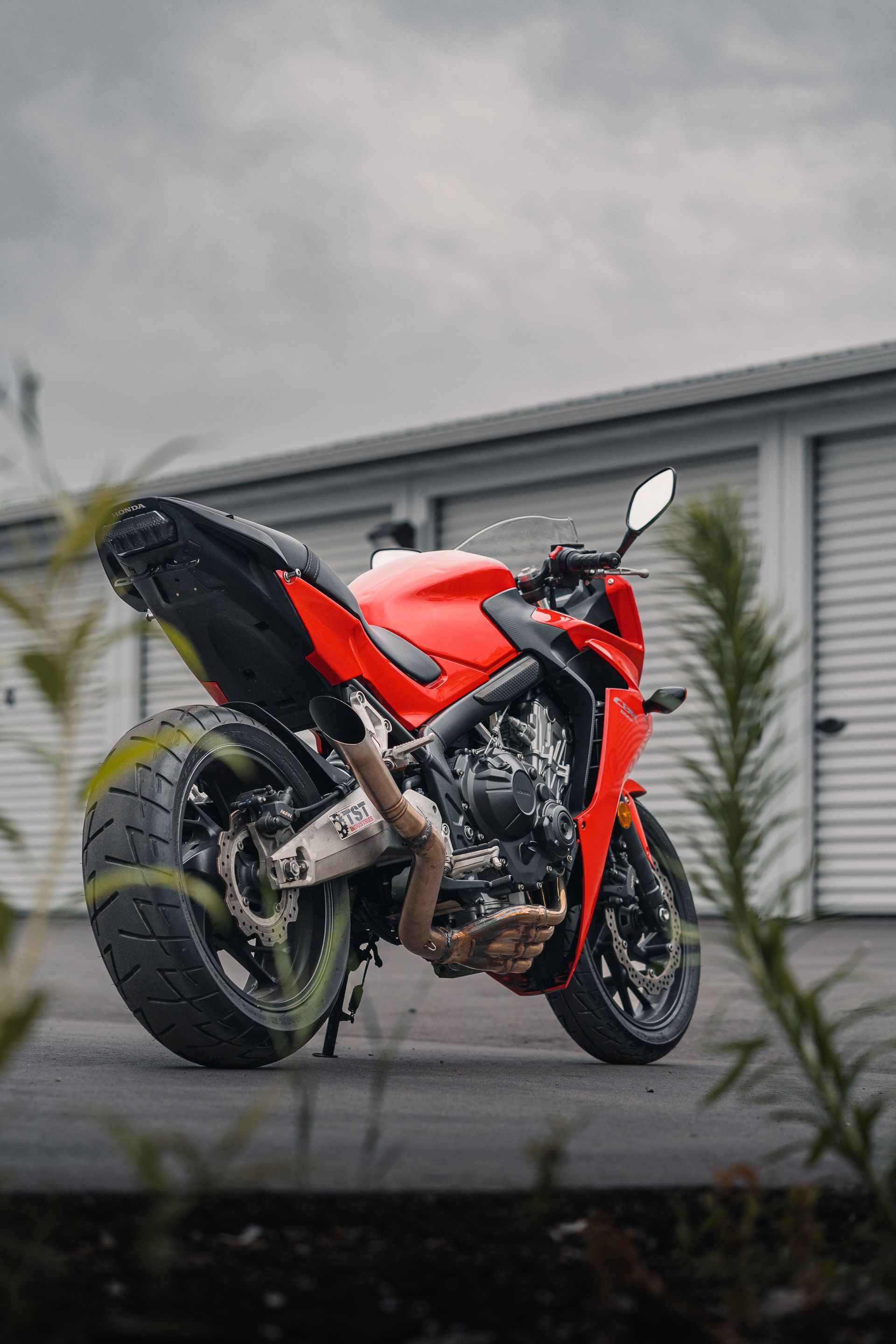 A yellow sports car is parked in a garage.