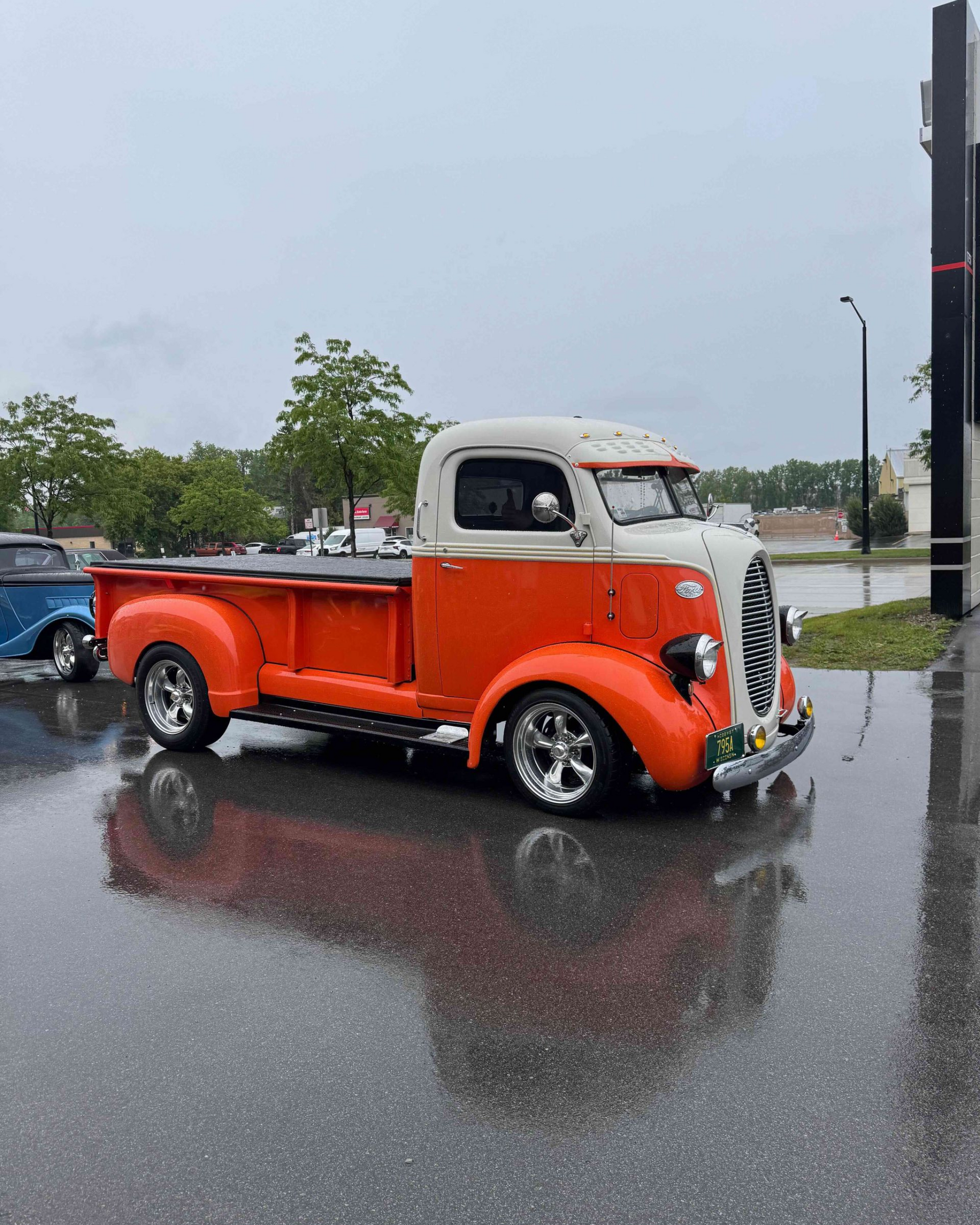 A yellow sports car is parked in a garage.