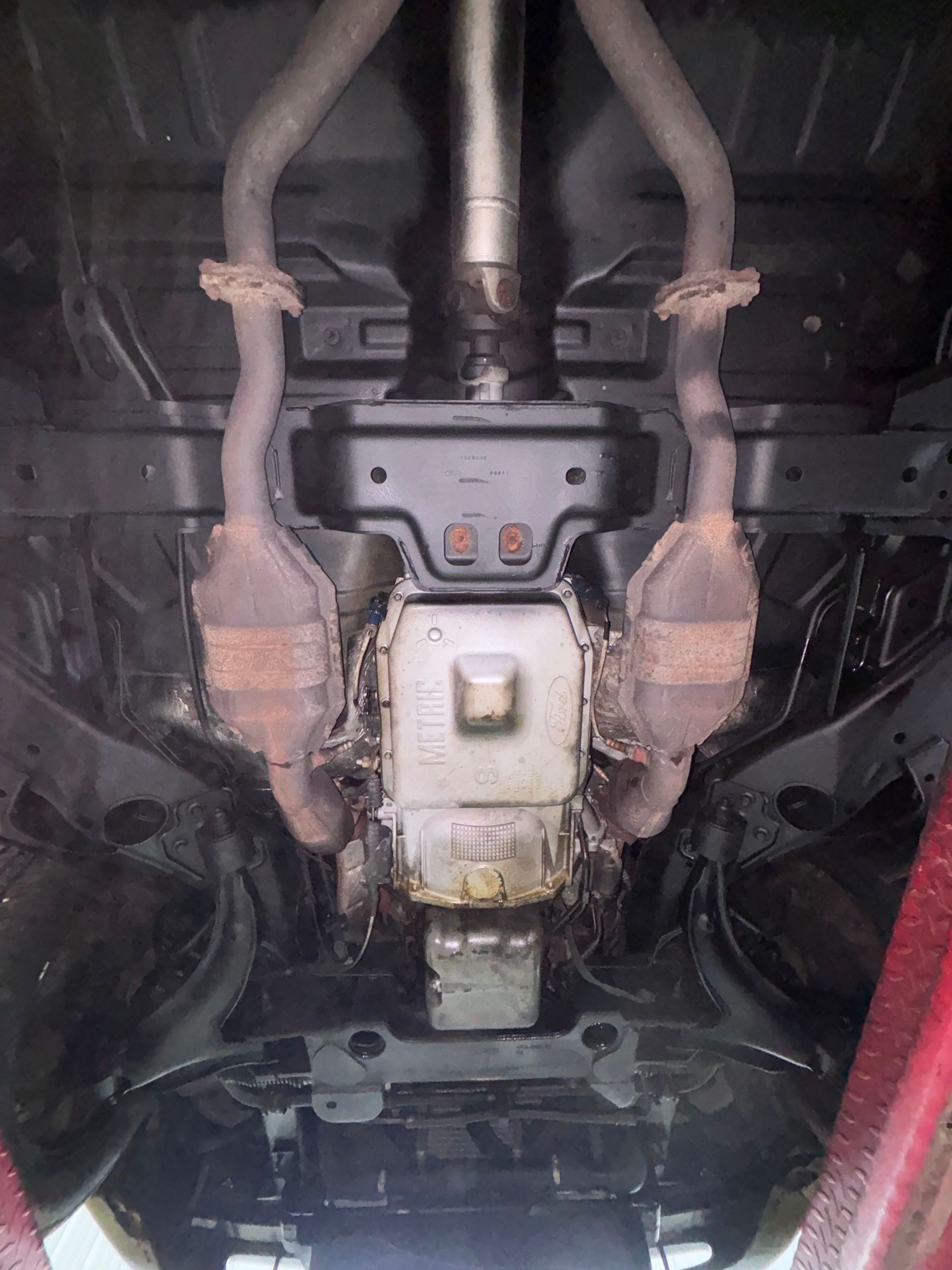 A yellow sports car is parked in a garage.