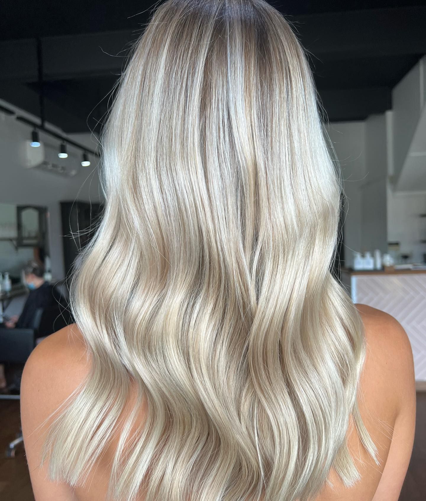 Blonde hair with crimped texture styled in loose waves.