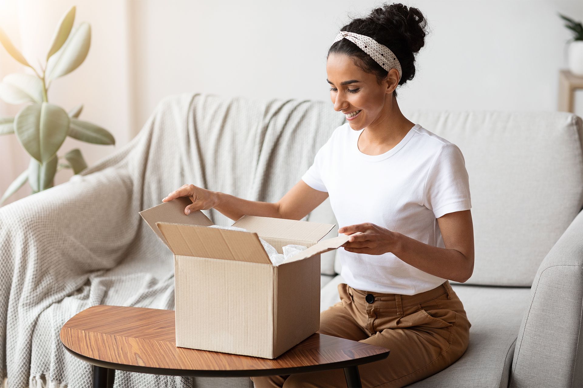 Smiling Woman Unpacking Her Package