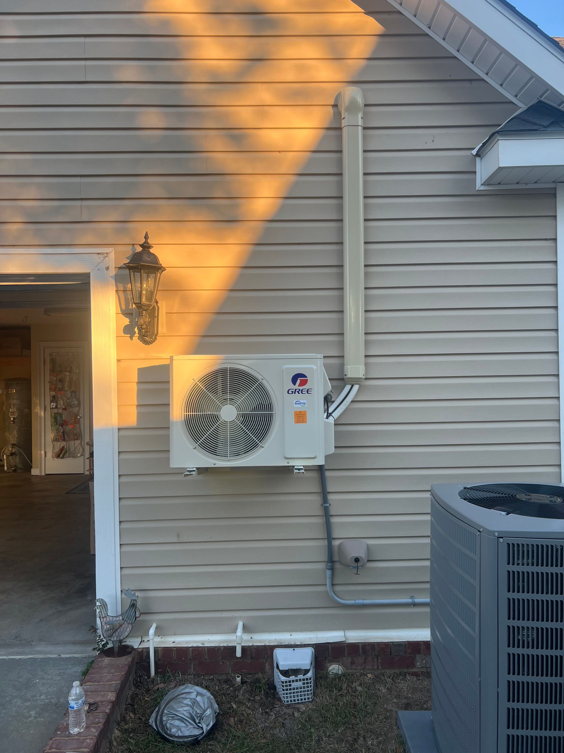 The sun is casting a shadow on the side of a house.