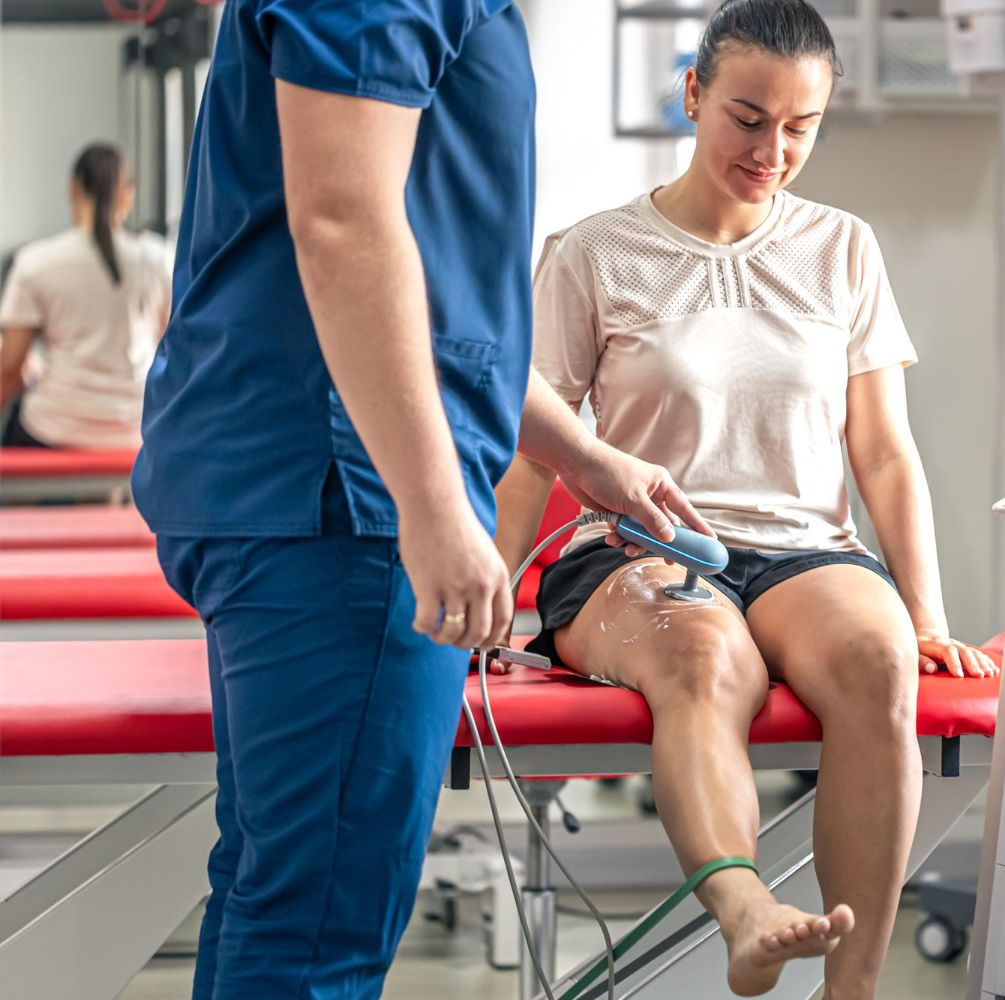 two men standing next to each other with their arms crossed