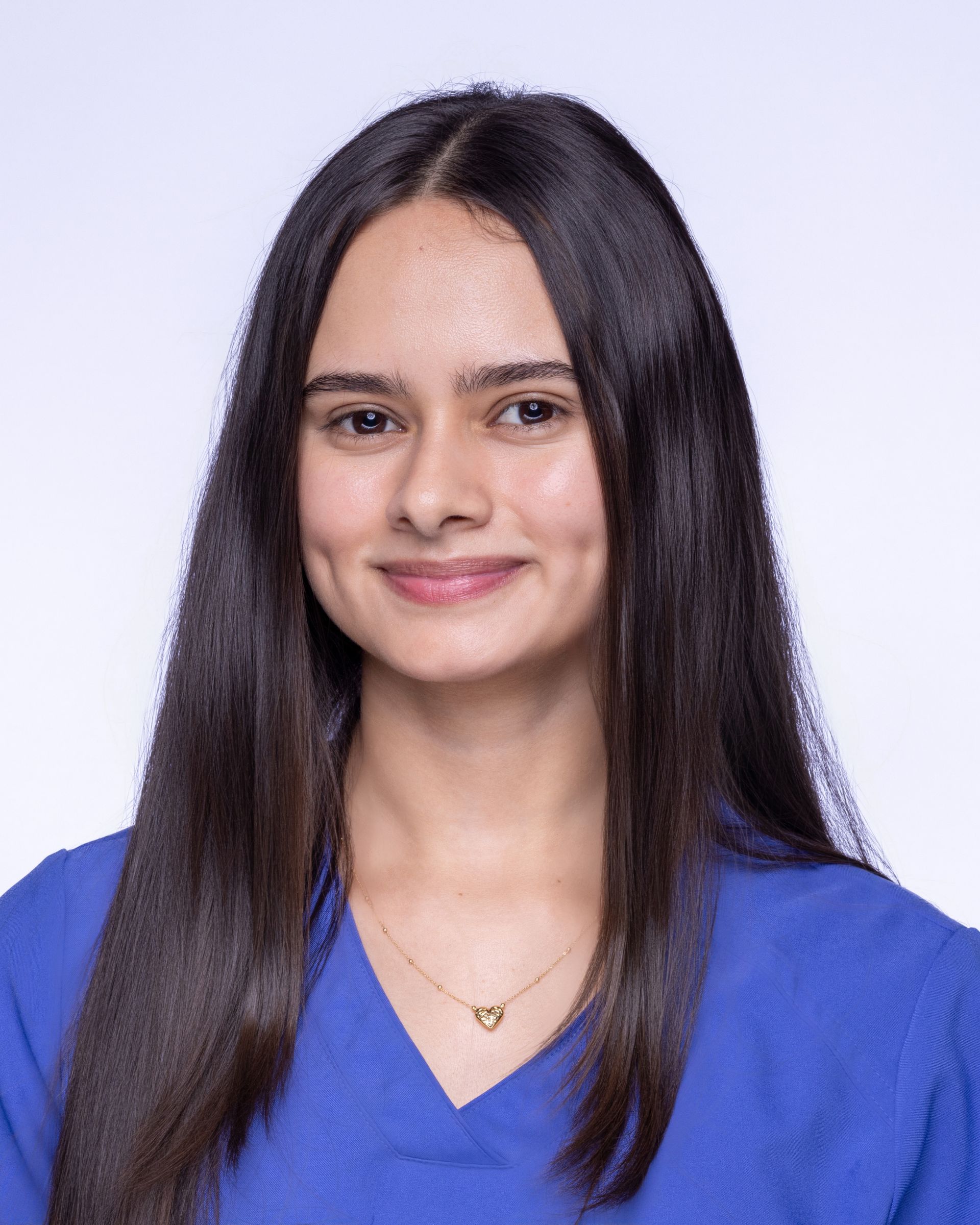 A man with a beard and a blue shirt is smiling for the camera.