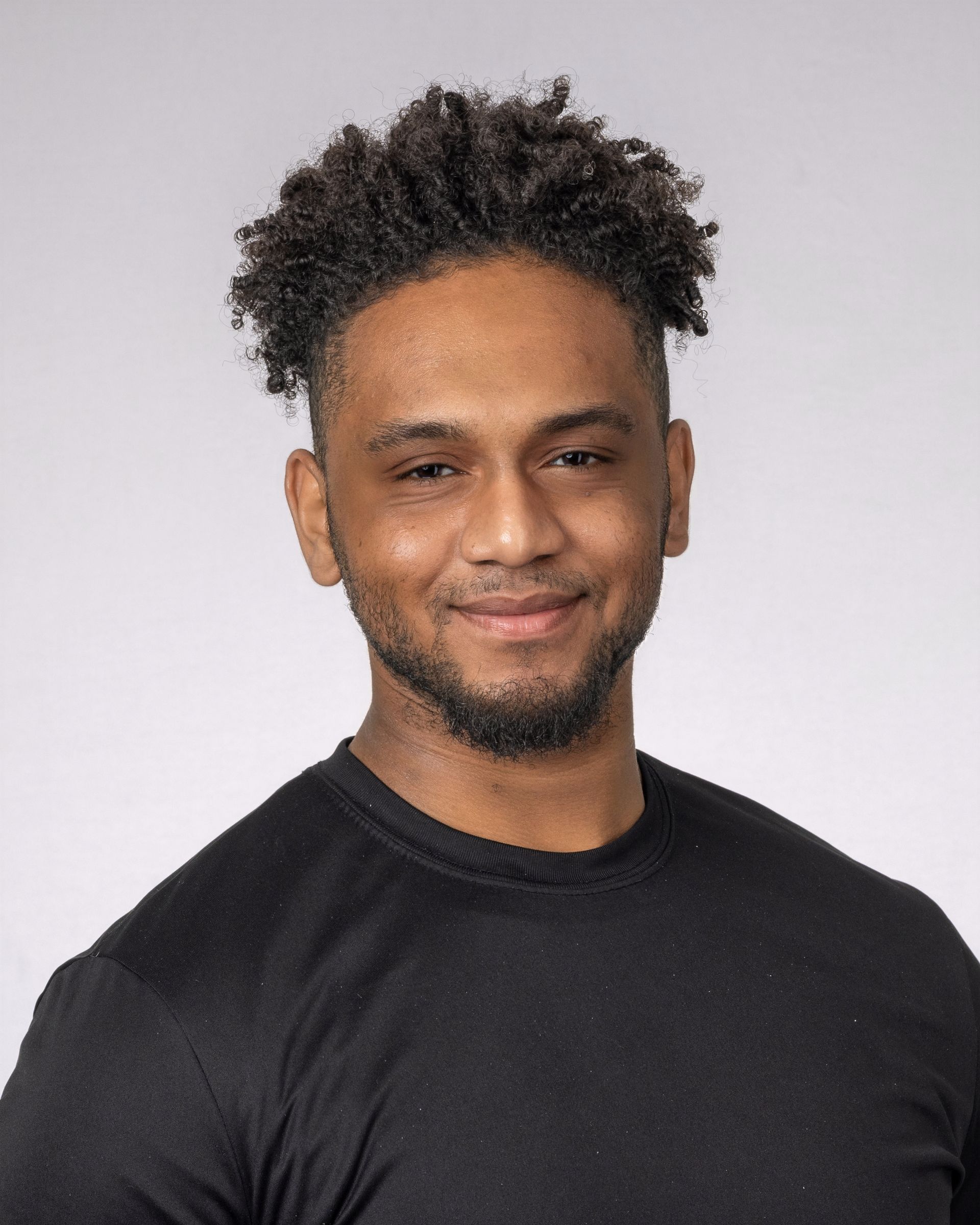 two men standing next to each other with their arms crossed