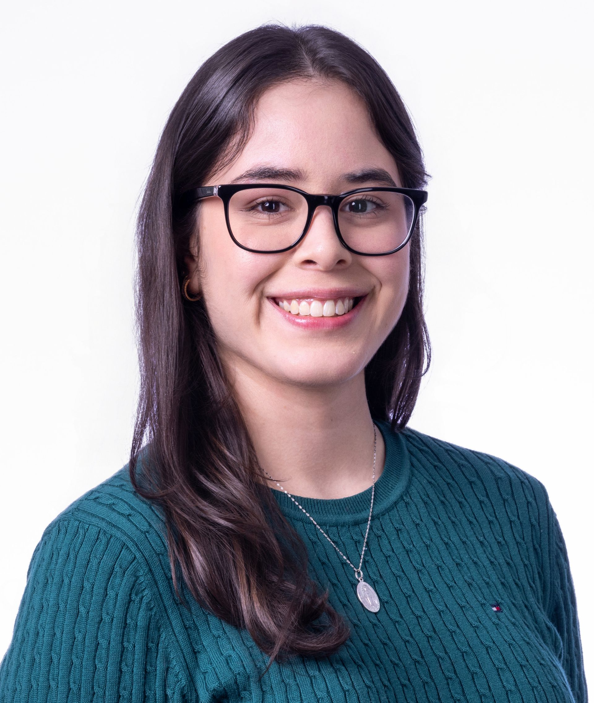 A man wearing glasses and a blue shirt is smiling for the camera.
