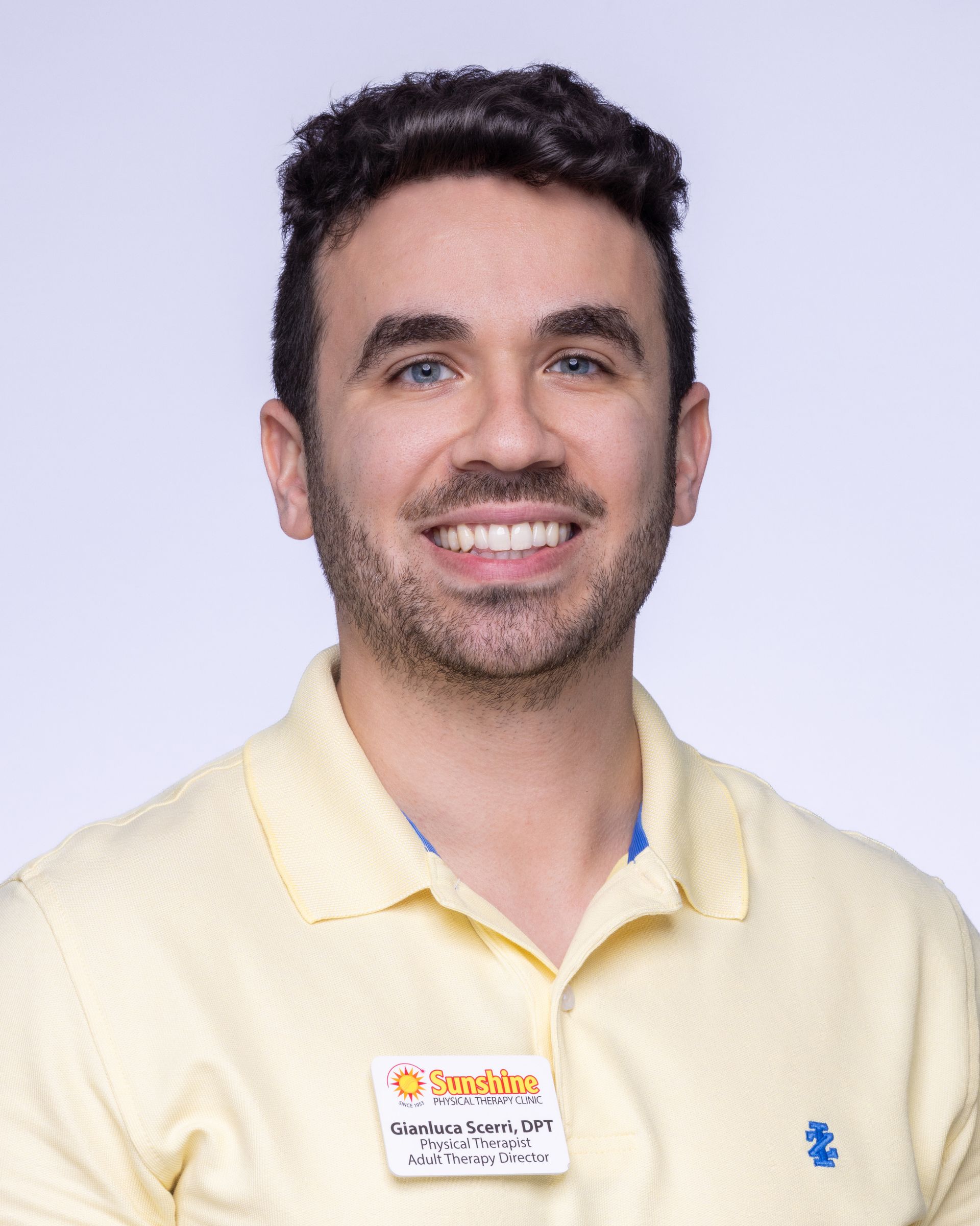 A bald man with a beard wearing a suit and white shirt