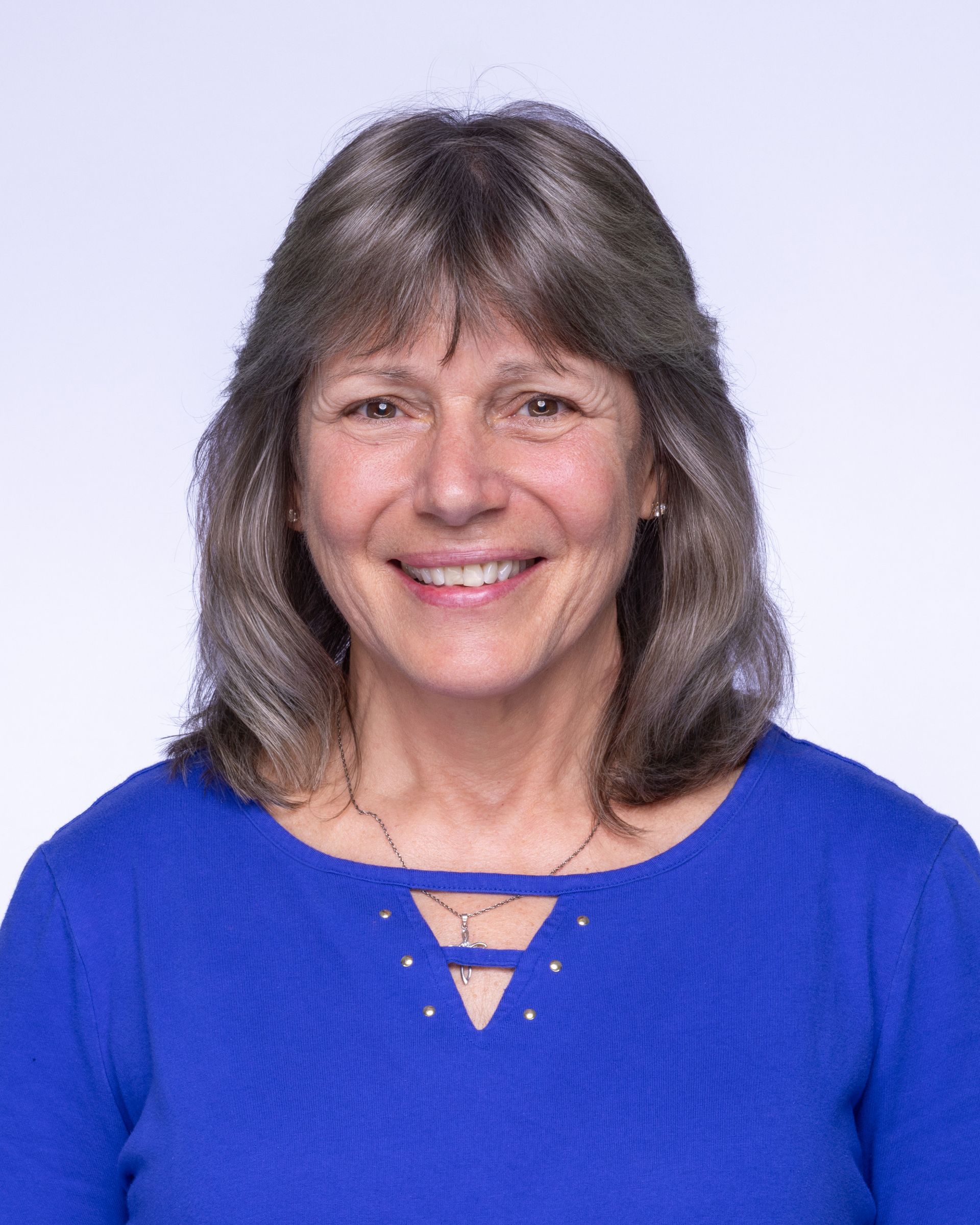 A bald man with a beard wearing a suit and white shirt