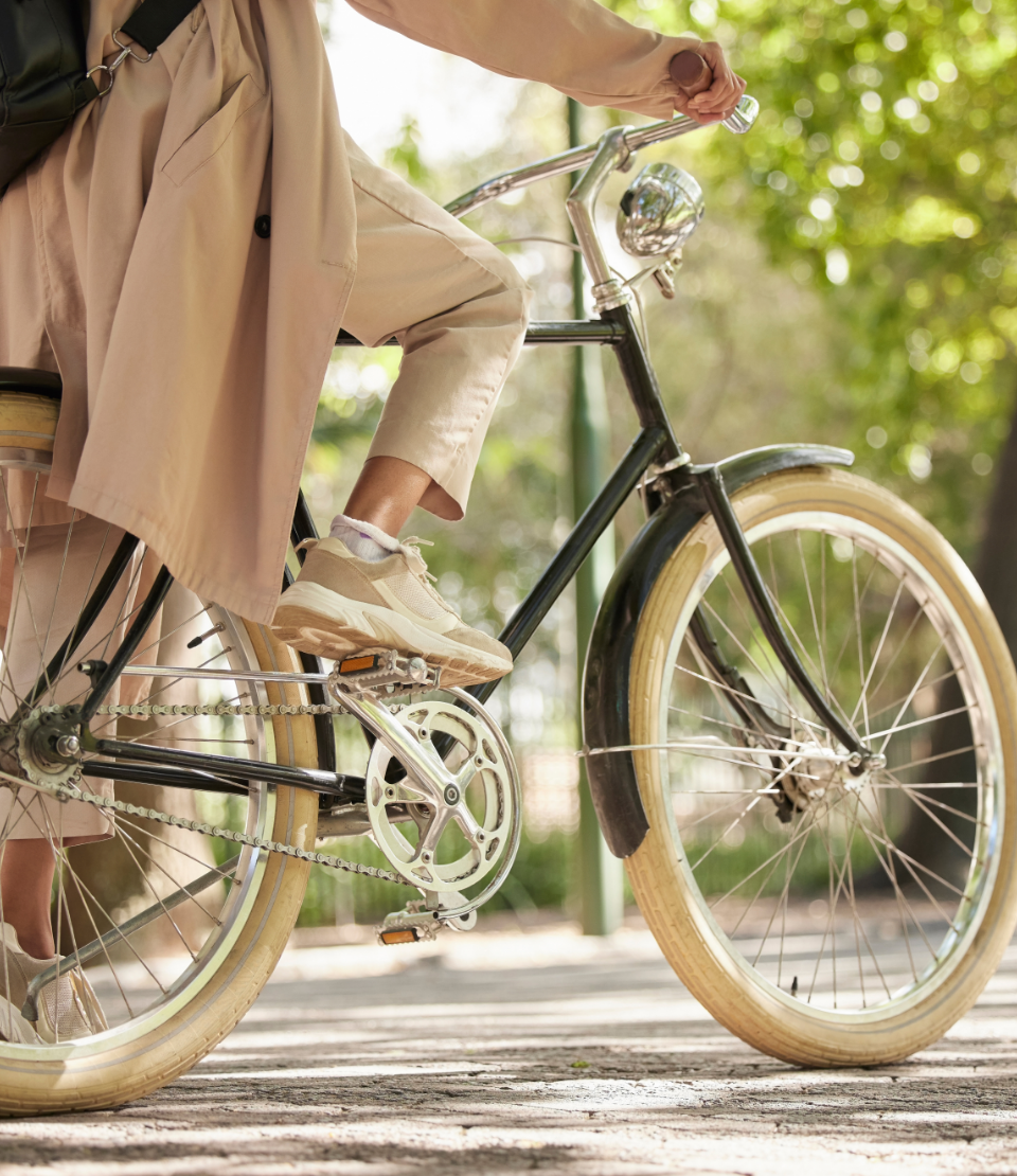 A woman is riding a bicycle on a sidewalk.