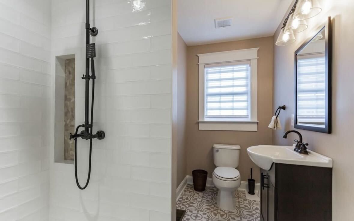 A bathroom with two sinks and a mirror