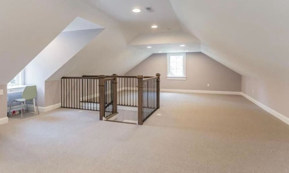 An empty hallway with stairs leading up to a door