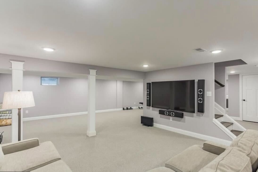 An empty living room with a fireplace and windows